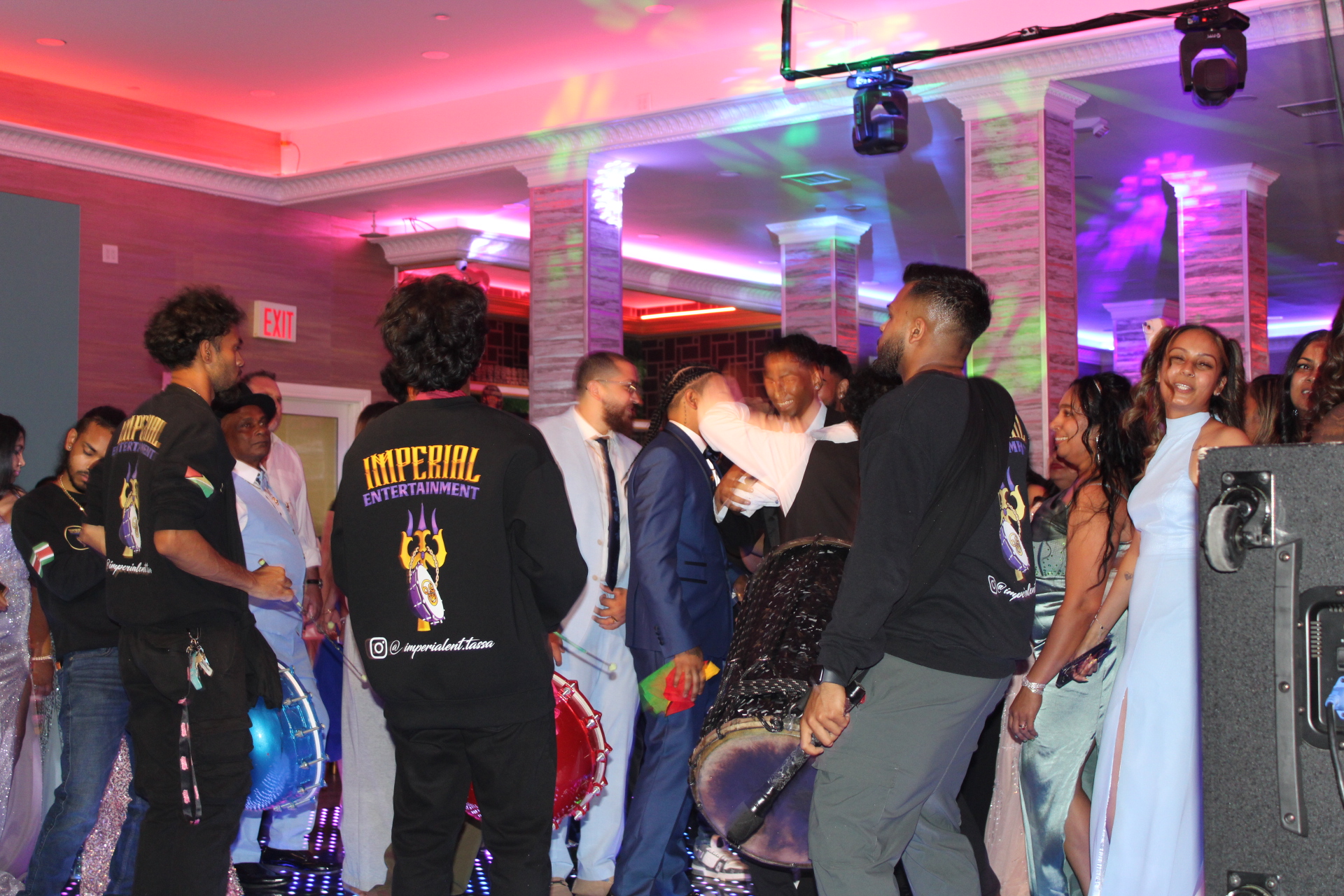 Wedding guests dancing with live tassa drummers